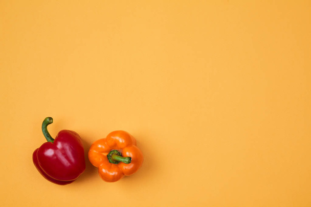 Colorful fruit pattern or background. Two peppers placed on colorful background - Photo, image