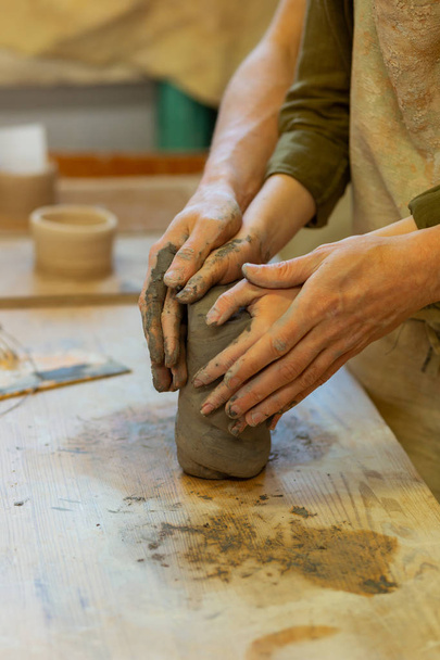 Ardent young couple having romantic masterclass in pottery workshop - Photo, Image