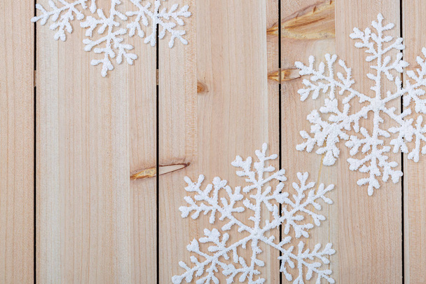 Christmas decoration background and copy space for text. White snowflakes on a wooden table. Happy Merry Christmas and New year. - Photo, Image