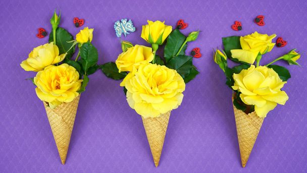 Summertime concept with ice cream cones filled with fruit, flowers and candy. - Valokuva, kuva