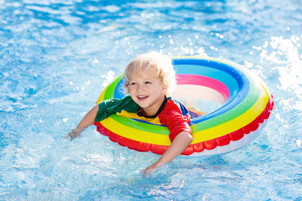 Child in swimming pool on toy ring. Kids swim. - Foto, Imagen
