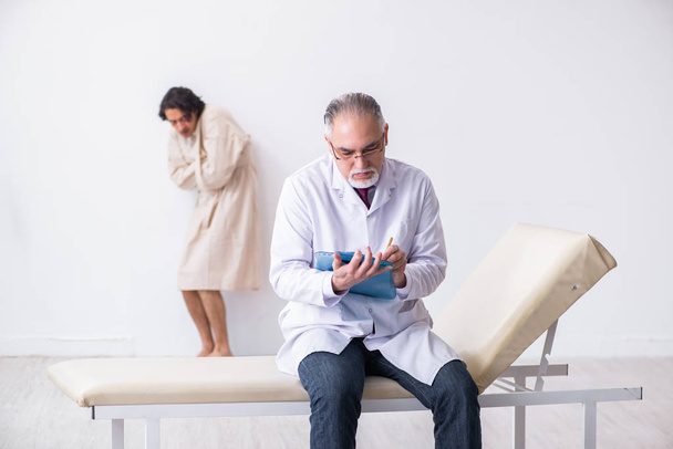 Médecin psychiatre homme âgé examinant un jeune patient  - Photo, image