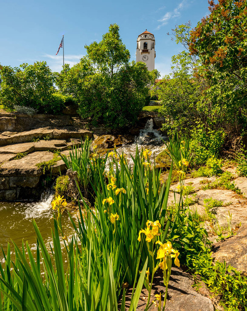 Цветочный сад в местном городском парке с водопадом и депо
 - Фото, изображение