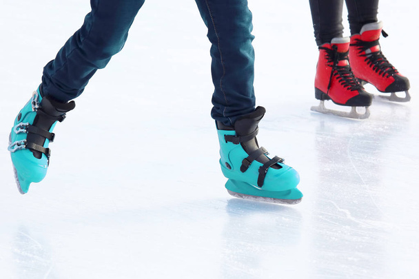 feet of different people skating on the ice rink - Photo, Image
