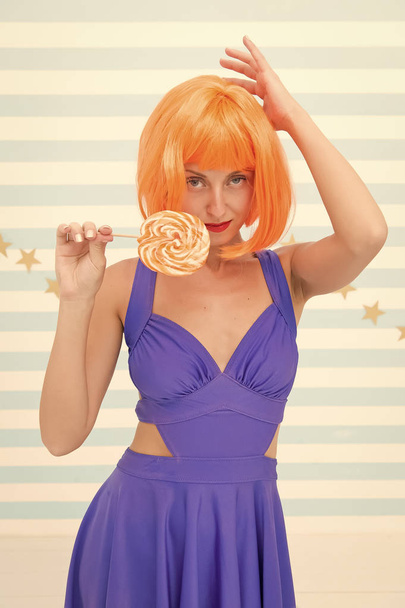 Fashion girl with orange hair having fun. Cool girl with lollipop. Sexy woman. happy pinup model with lollipop in hand. Crazy girl in playful mood. Going crazy. Enjoy party. Sweet look. So much fun - Φωτογραφία, εικόνα