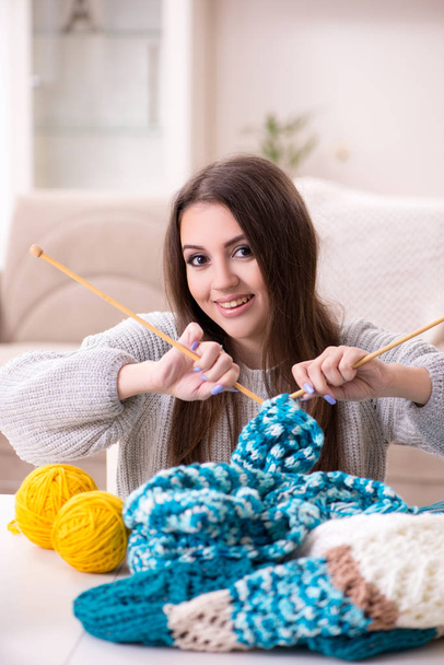 Young beautiful woman knitting at home - 写真・画像