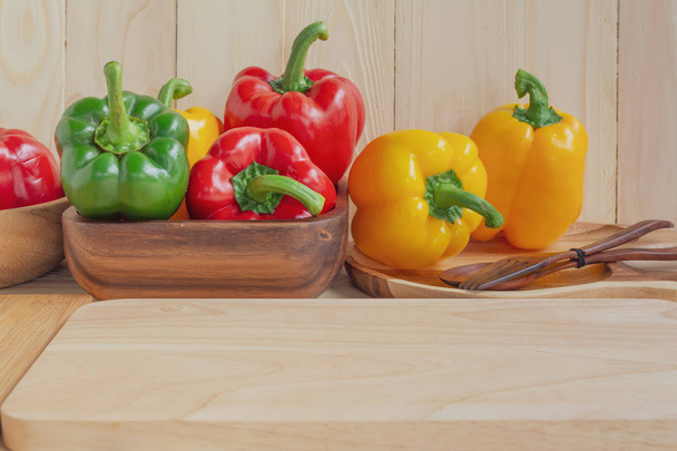 sweet peppers on wooden table background - Foto, afbeelding