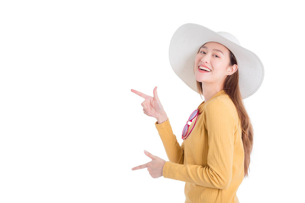Beautiful girl  wearing hat and pointing to copy space  - Zdjęcie, obraz