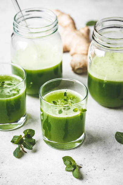 Green detox juice with ginger and mint in glasses and jars.  - Fotoğraf, Görsel