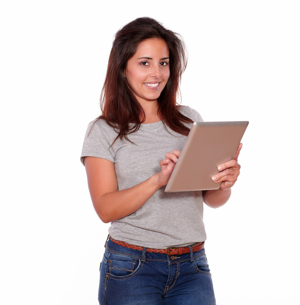 Smiling young woman using her tablet pc - Fotó, kép