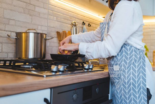 woman fry on pan kitchen view - 写真・画像