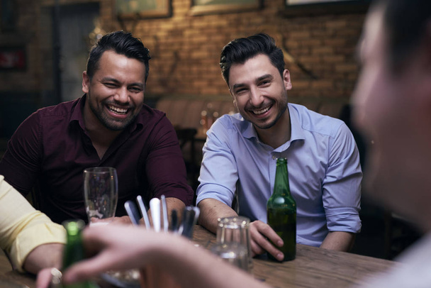 Two joyful men spending time in the pub  - Photo, Image