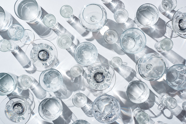 top view of transparent glasses with clear water on white background - Zdjęcie, obraz