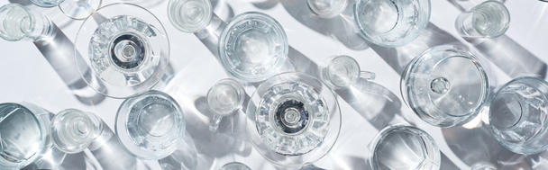 top view of transparent glasses with water on white background, panoramic shot - Fotoğraf, Görsel