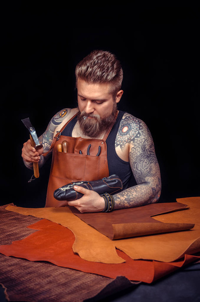 Leather master creates quality product of leather at a workshop - Photo, Image