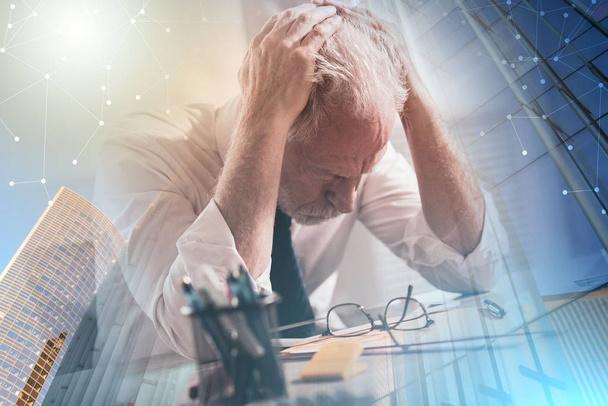 Stressed businessman sitting in office; multiple exposure - Photo, Image