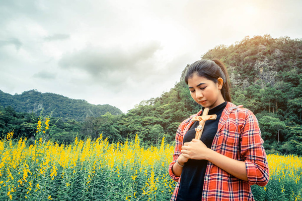 Young beautiful woman praying on nature background - Photo, Image