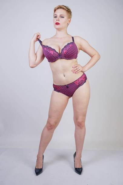 Beautiful young caucasian chubby woman with plus size body and pale skin wearing lace sexy lingerie on white studio background alone - Φωτογραφία, εικόνα