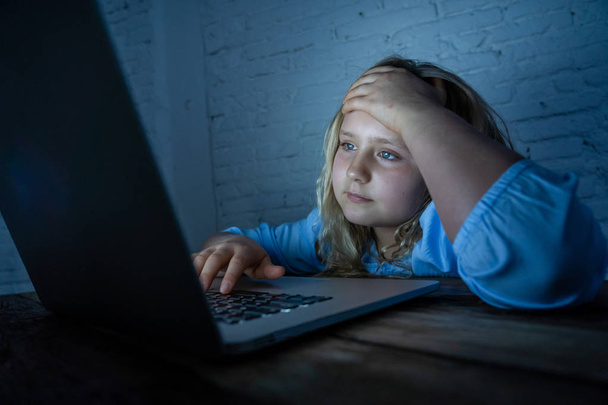 Scared sad girl bullied online on laptop suffering cyber bullying harassment. School girl humiliated on the internet by classmates feeling desperate and intimidated. Children victim of bullying. - Фото, изображение
