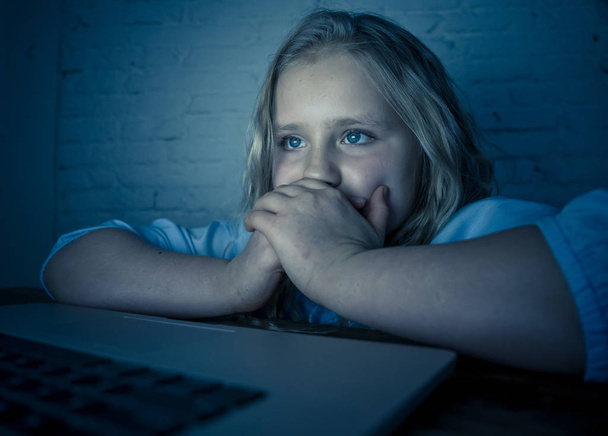 Scared sad girl bullied online on laptop suffering cyber bullying harassment. School girl humiliated on the internet by classmates feeling desperate and intimidated. Children victim of bullying. - Photo, Image