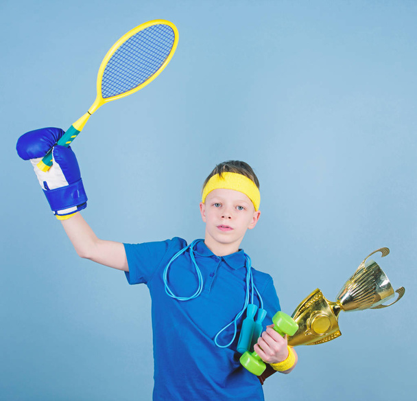 Success in sport. Succeed in everything. Athlete successful boy sport equipment jump rope boxing glove tennis racket roller skate and golden goblet. Success and award. Proud of achieved success - Fotografie, Obrázek