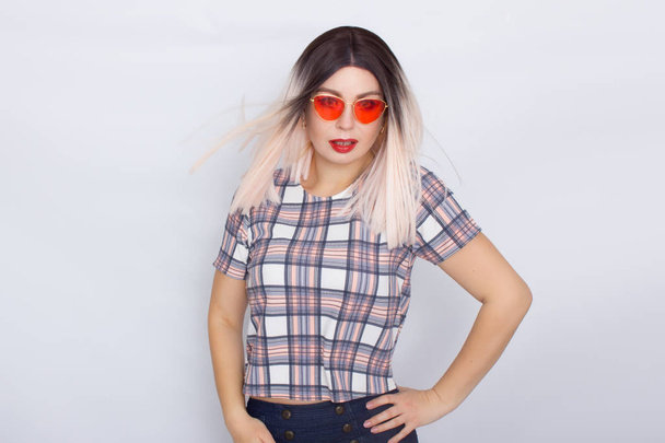 Blonde woman wearing sunglasses over white background - Photo, image