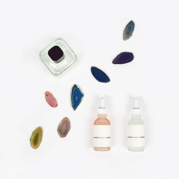 Organic pharmacy cosmetics with natural agate stone on white background. Flat lay. Top view of bottles of cream. Natural beauty products for branding mock-up concept. Clean beauty concept. - Foto, imagen