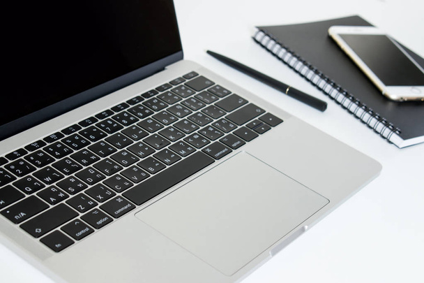 Seitenansicht des Laptops auf einem modernen Schreibtisch. schwarzer Bildschirm. - Foto, Bild