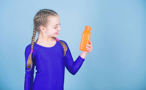 Kid cute girl gymnast sports leotard hold bottle for drink. Water balance and hard gym training. Drink more water. Keep water bottle with you. Quench thirst. Child feel thirst after sport training - Fotografie, Obrázek