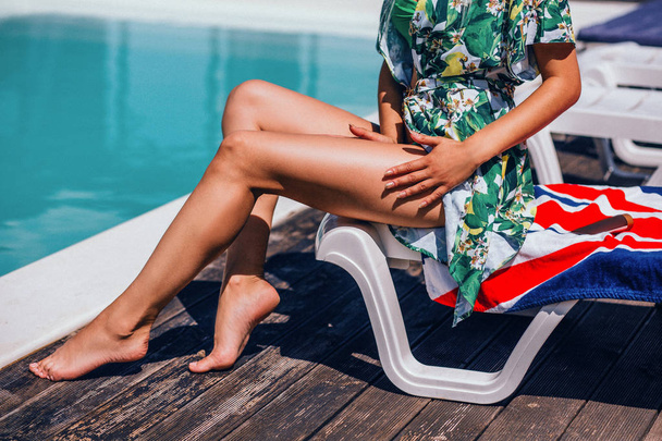 Beautiful long womans legs on pool background. Hot girl near a pool. - Foto, imagen