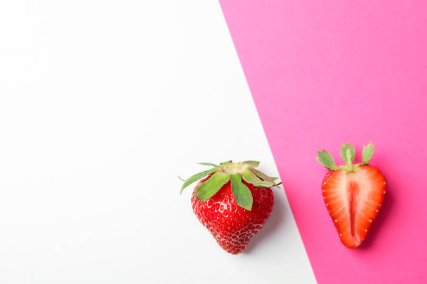 Strawberries on two color background, space for text. Summer swe - Photo, Image