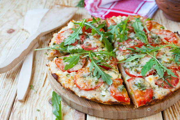 homemade pizza with tomatoes, cheese and arugula - Fotó, kép