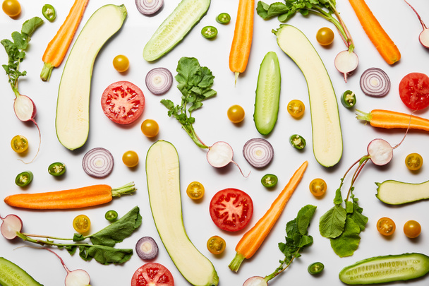 top view of fresh sliced organic vegetables on white background - Fotó, kép