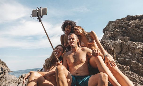 group of three young multiracial friends taking a selfie on a ro - Φωτογραφία, εικόνα