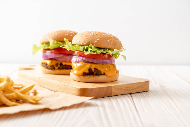 fresh tasty beef burger with cheese and french fries - 写真・画像