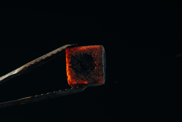 hookah tongs and hot coal isolated on black - Fotó, kép