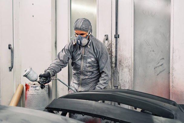 A man painting a car - Photo, image