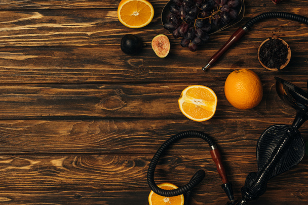 top view of fresh exotic fruits and hookah on wooden surface - Photo, Image