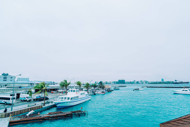 HULHULE, MALDIVES - MAY 23, 2019: Boats and ferries at the harbo - 写真・画像