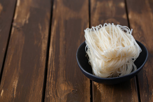 uncooked rice noodles on table - Fotoğraf, Görsel