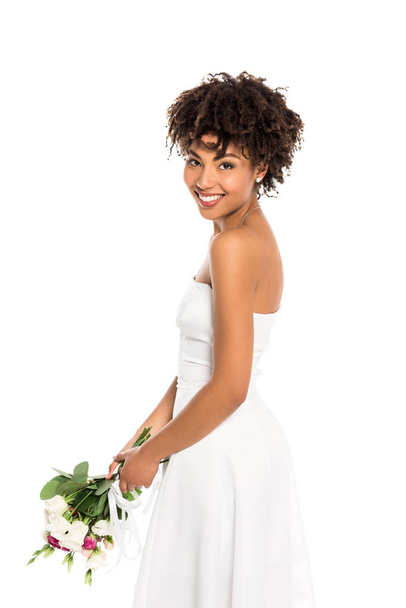  curly african american bride holding bouquet and looking at camera isolated on white  - Photo, Image