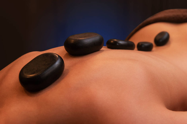 therapy with hot stones in spa center - Photo, Image