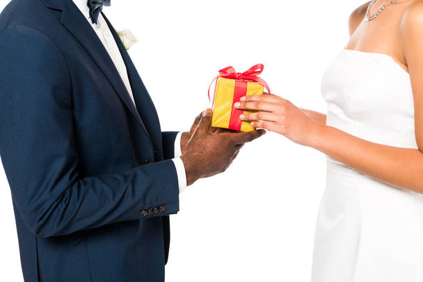 cropped view of african american bridegroom giving present to bride isolated on white  - Foto, Imagem