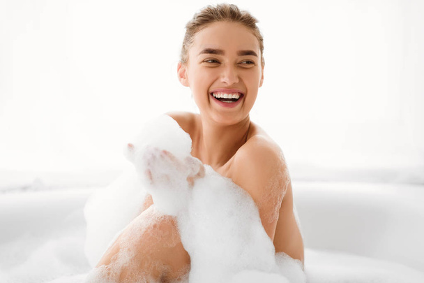 Happy Woman Playing With Foam In Bathtub - Photo, Image