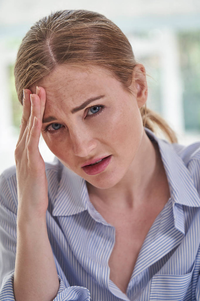 Portrait Of Stressed Businesswoman Suffering With Headache In Of - Photo, image