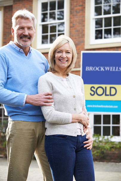 Portrait Of Mature Couple Standing Outside Dream Home Wit Sold S - Φωτογραφία, εικόνα