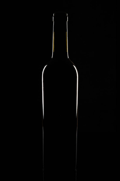 Isolated bordeaux wine bottle, dark background silhouette - Photo, Image