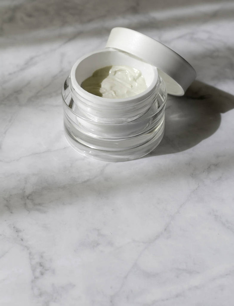 Jar with cosmetic cream, natural hard light, deep shadows at mar - Photo, image