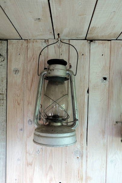 Kerosene lamp on rustic wooden planks background - Photo, Image