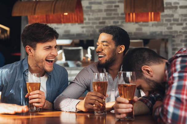 Friends Meeting. Men Drinking Beer And Talking In Bar - Zdjęcie, obraz